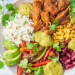 Chicken fajita bowl on a blue background.