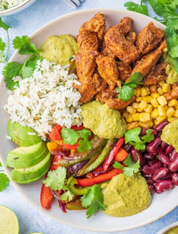 Chicken fajita bowl on a blue background.