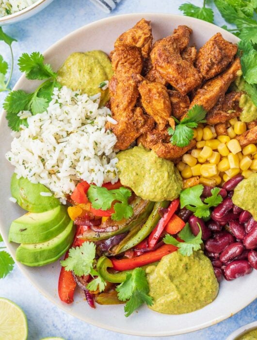 Chicken fajita bowl on a blue background.