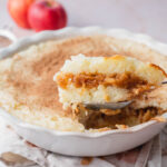 Polish rice with apples in a casserole dish.