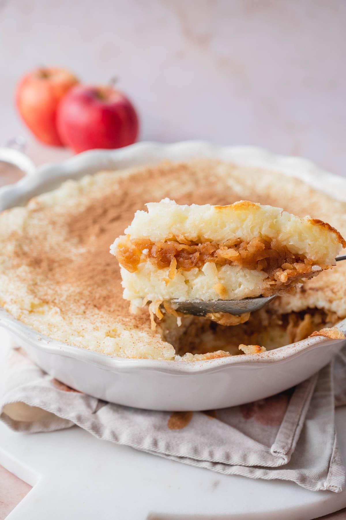 Polish rice and apples in a white pie dish.