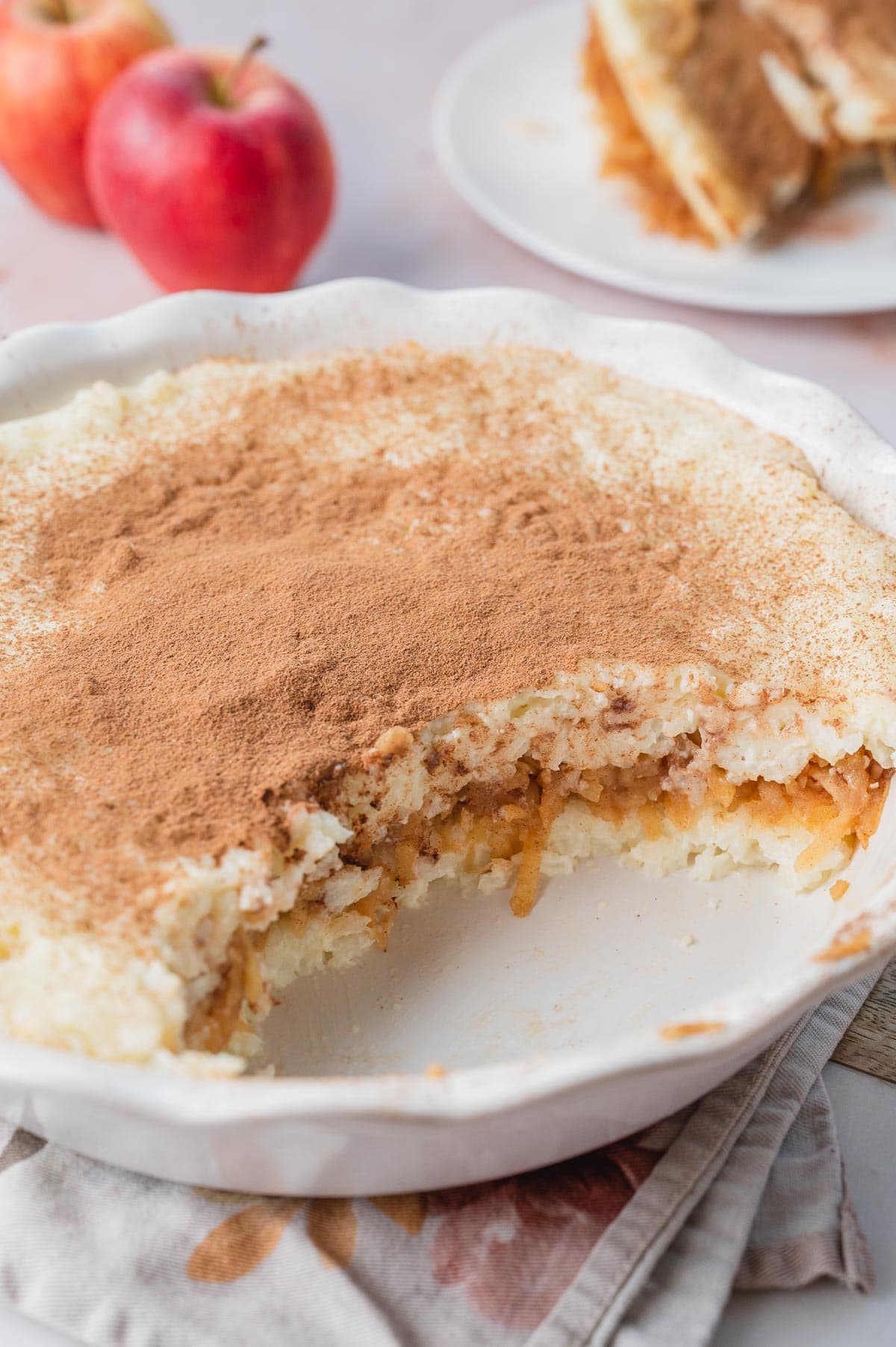 Polish rice and apples in a white pie dish with a serving missing.