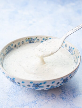 Ranch dressing in a white-blue bowl.