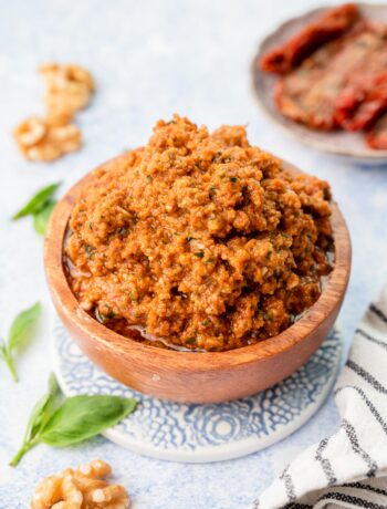 Sun-dried tomato pesto in a brown bowl.