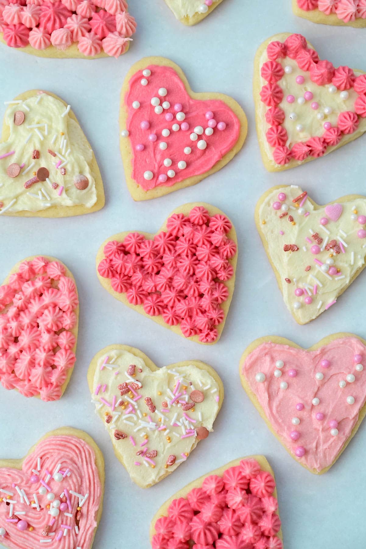 Valentines's Day Cookies with pink frosting on a light blue backgroung.