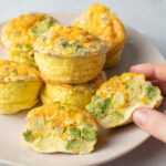 Broccoli cheddar egg muffins on a beige plate.