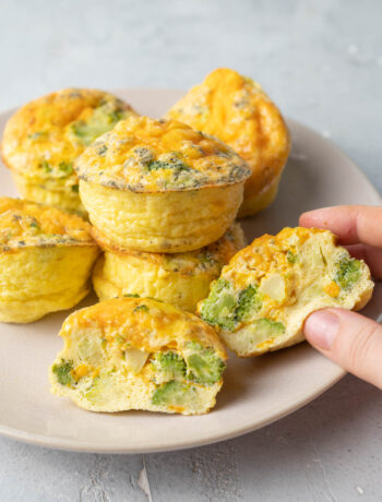 Broccoli cheddar egg muffins on a beige plate.