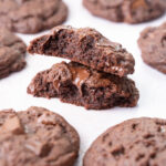 Double chocolate chip cookies on a light grey background.