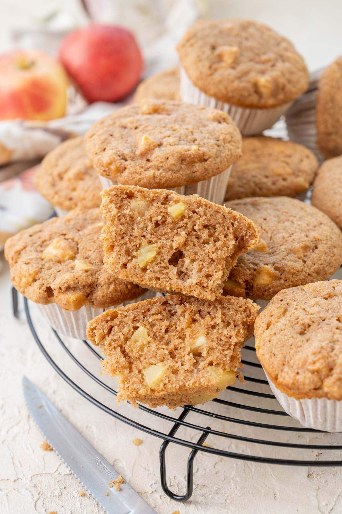 Apple muffins on a black cooling rack.