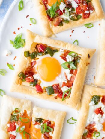 Puff pastry breakfast tarts on a white plate.