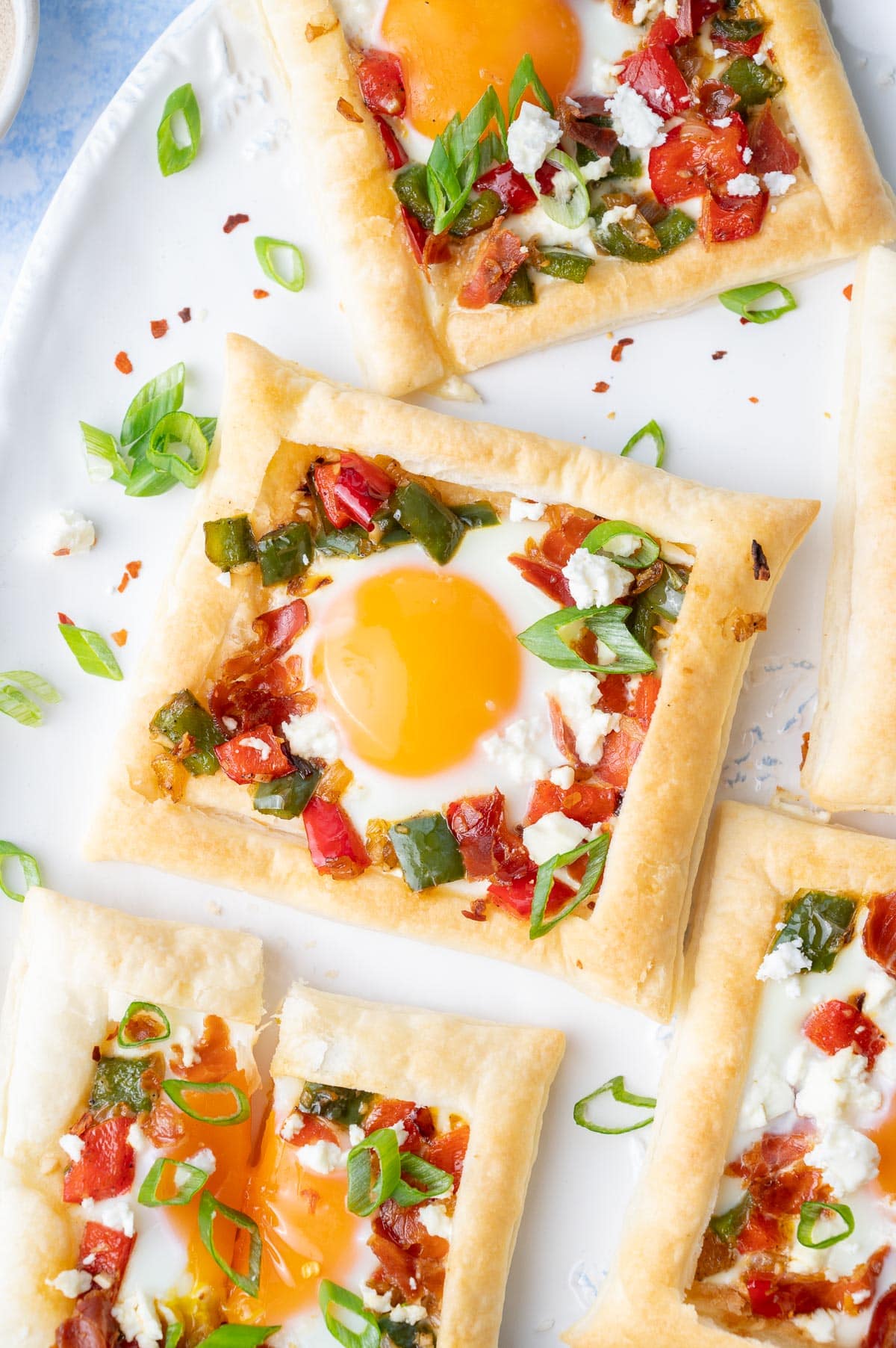 A close up picture of puff pastry breakfast tart on a white plate.
