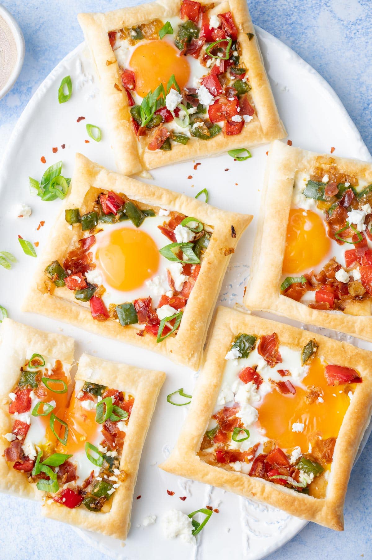 Puff pastry breakfast tarts on a white plate.