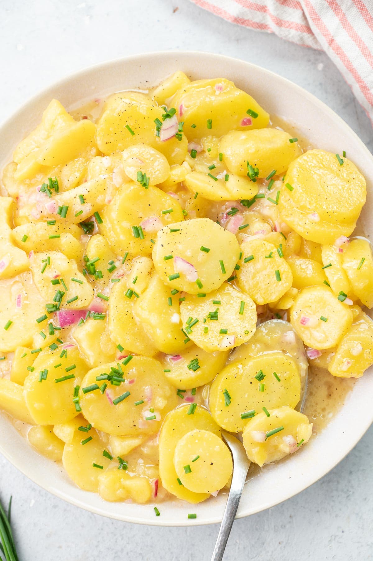 Austruan potato salad in a white bowl.