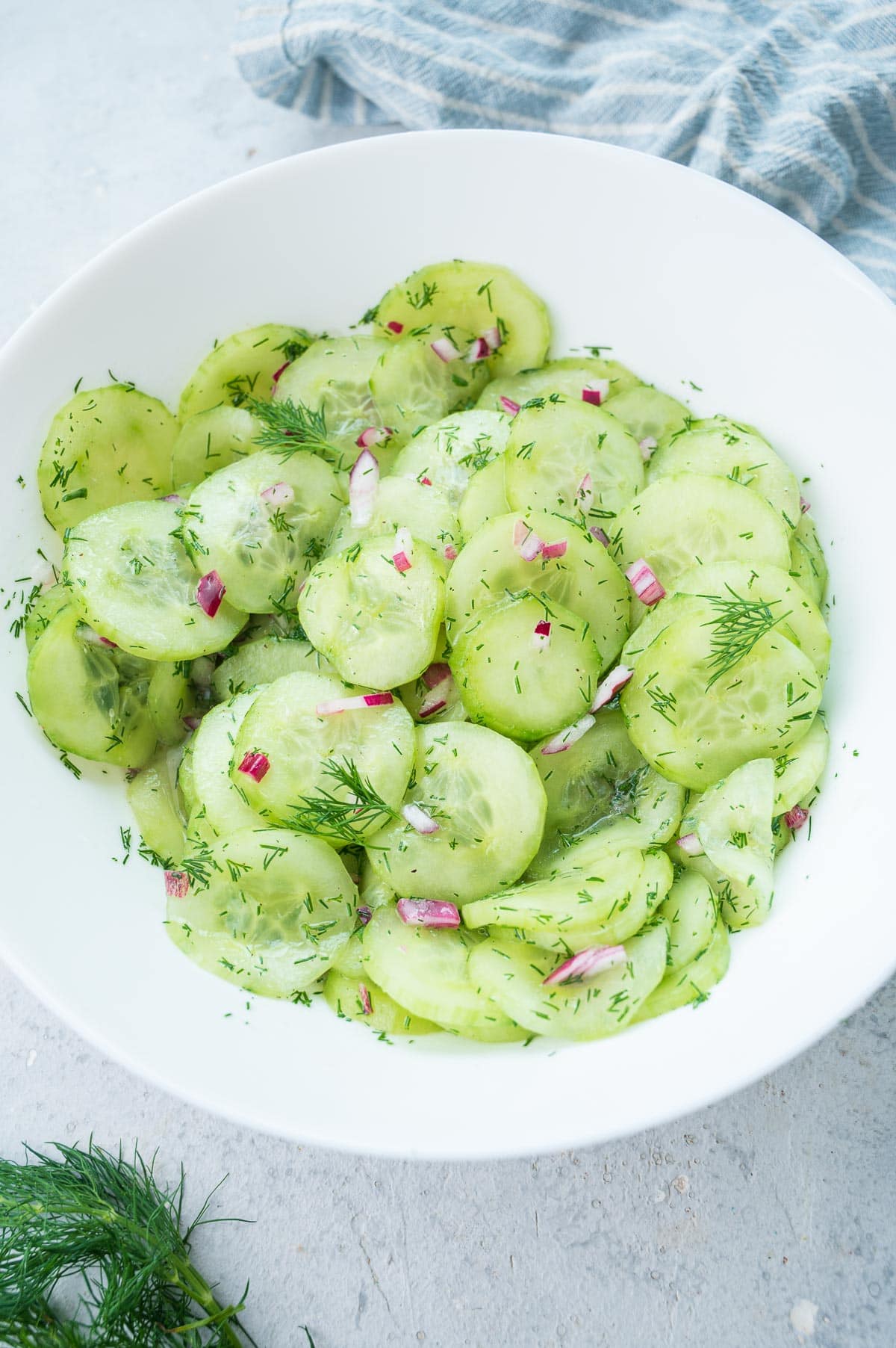 German cucumber salad in a white plate.
