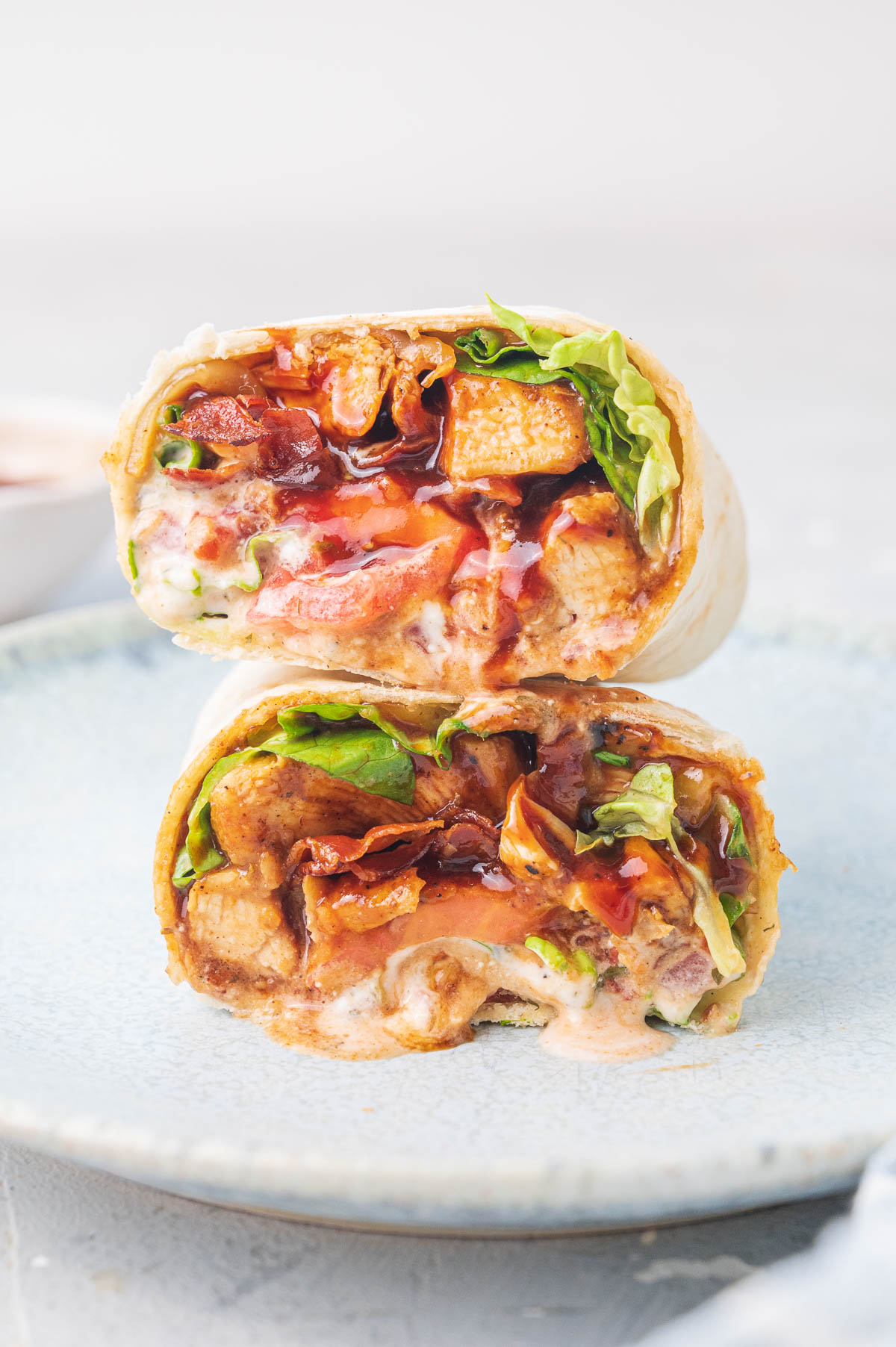 A stack of two bbq chicken wraps cut in half.