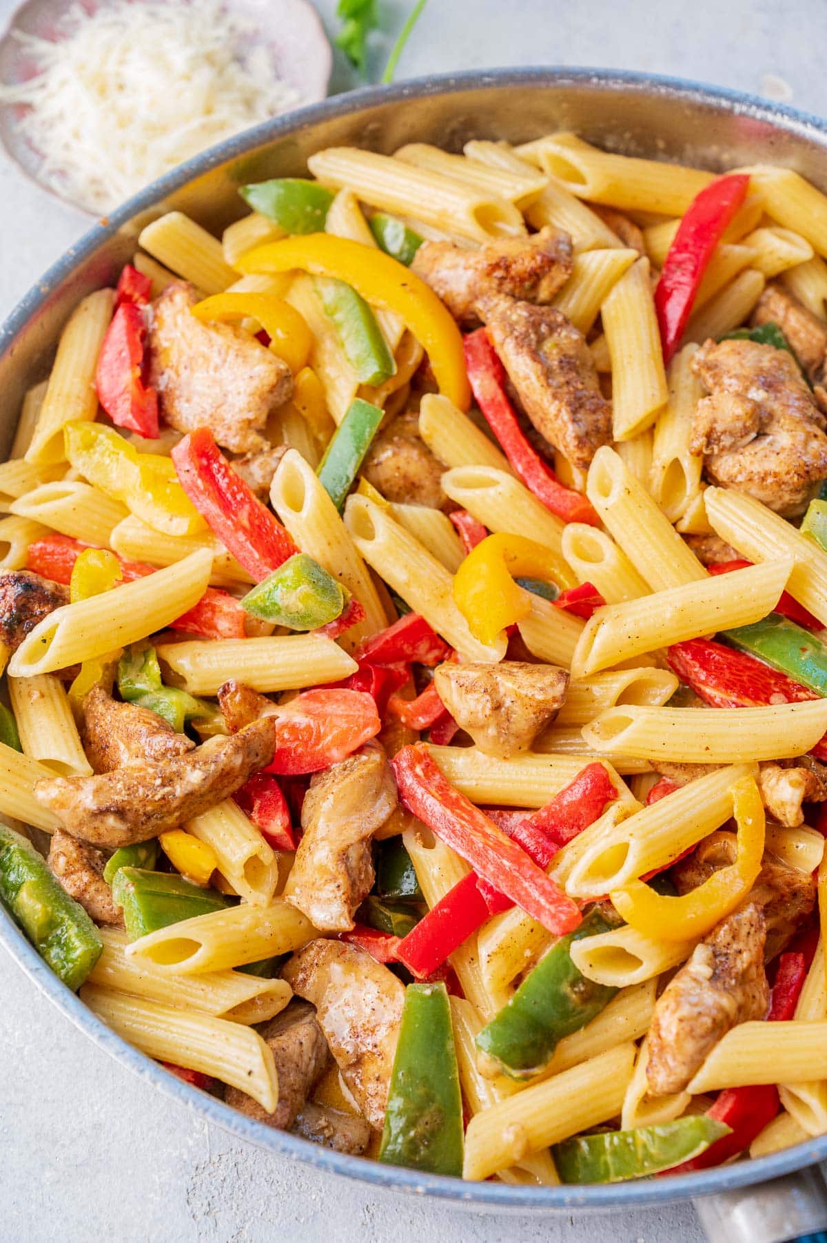 Jerk chicken pasta in a pan.