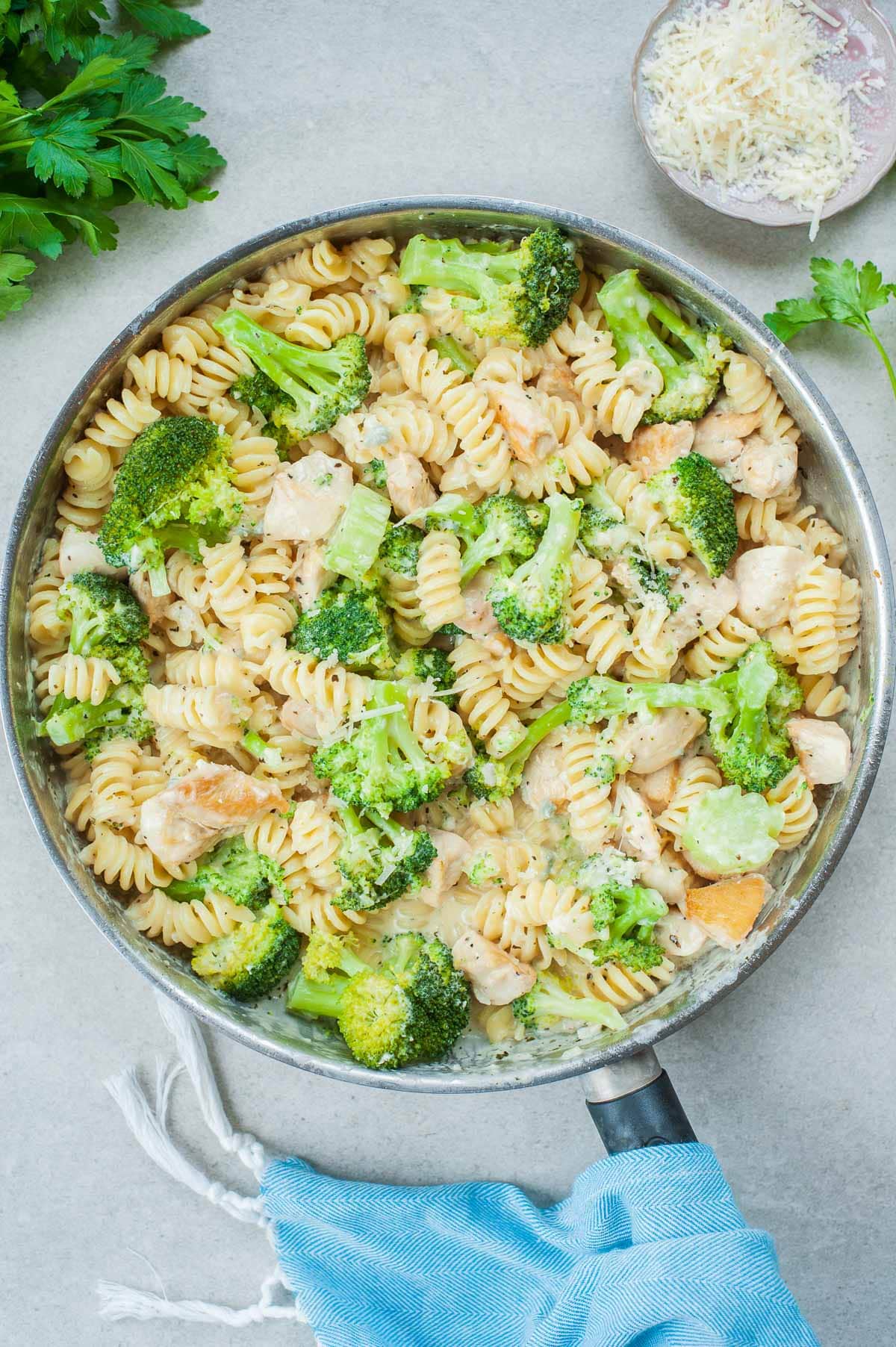 Four cheese pasta with chicken and broccoli in a frying pan.