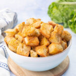 Homemade croutons in a blue bowl.