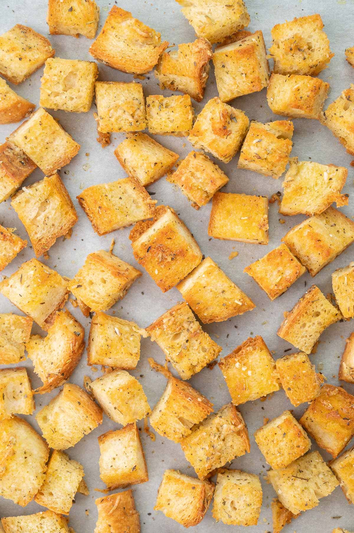 Homemade croutons on a baking sheet.