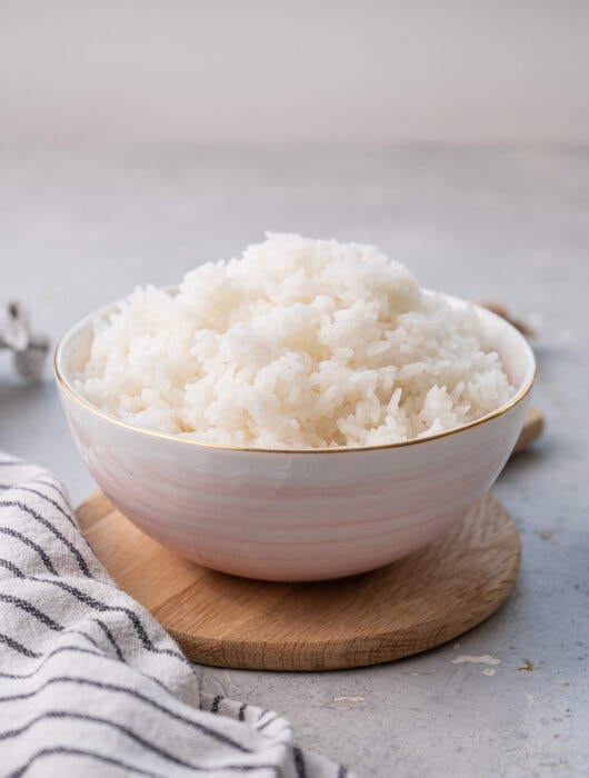 Cooked Jasmine rice in a pink bowl.