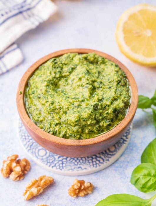 Basil walnut pesto in a brown bowl.