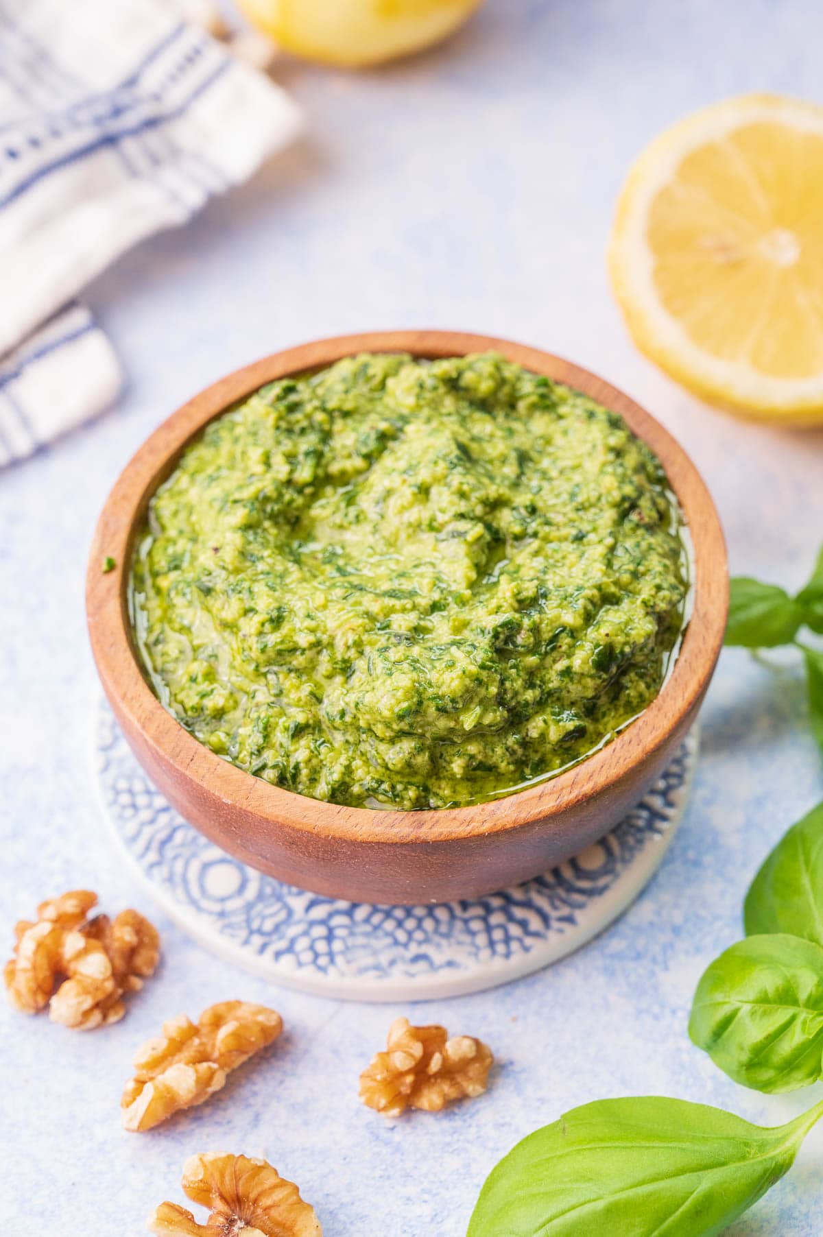 Basil walnut pesto in a brown bowl.