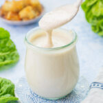 Caesar salad dressing in a small jar.