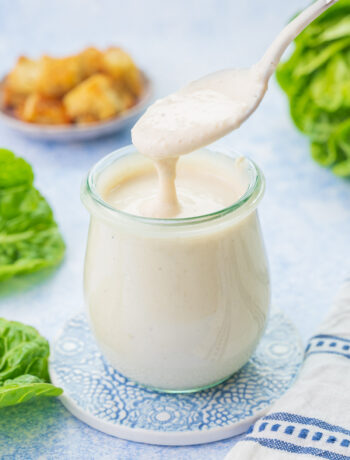 Caesar salad dressing in a small jar.