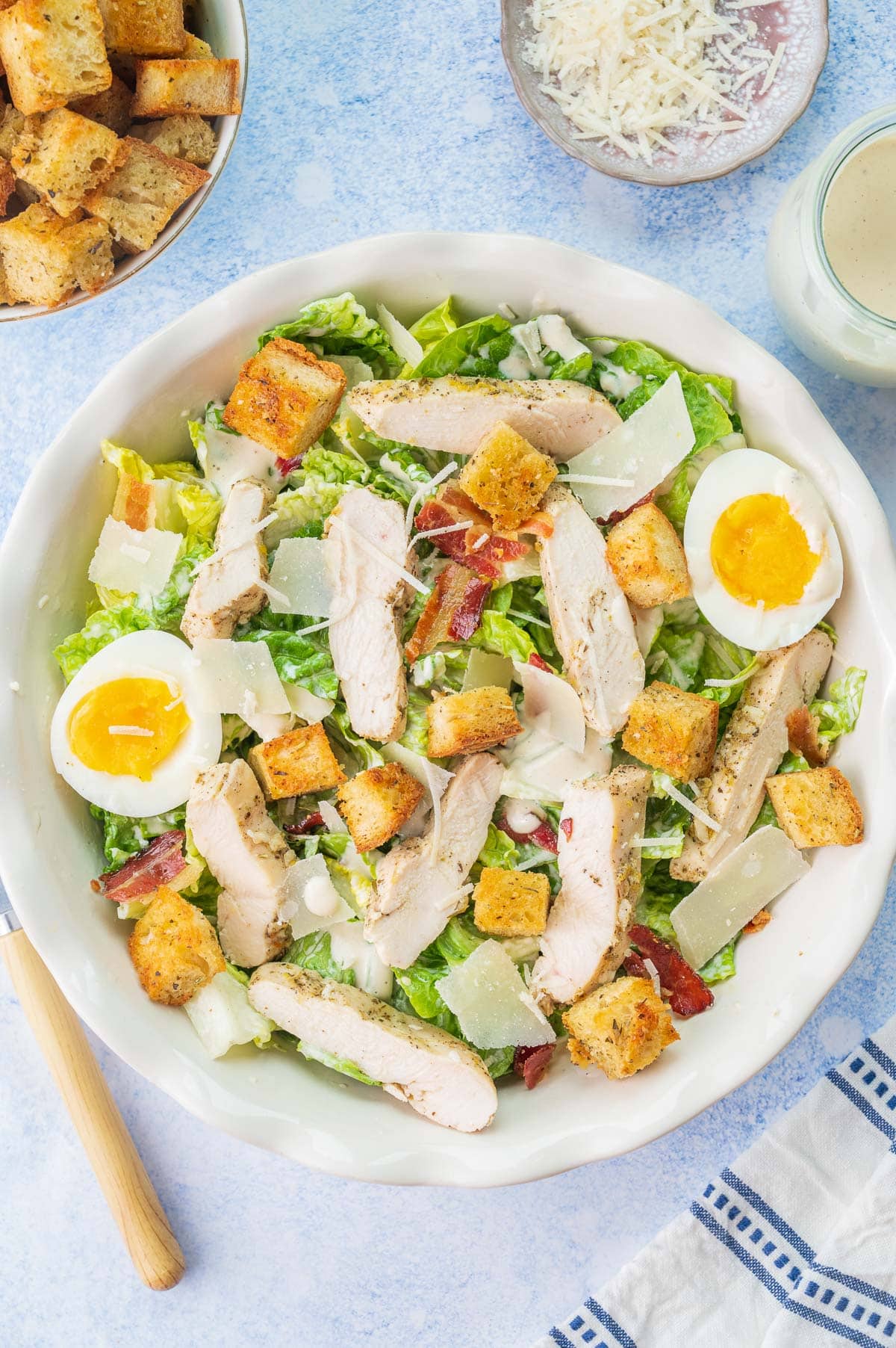 Chicken Caesar salad in a white bowl.