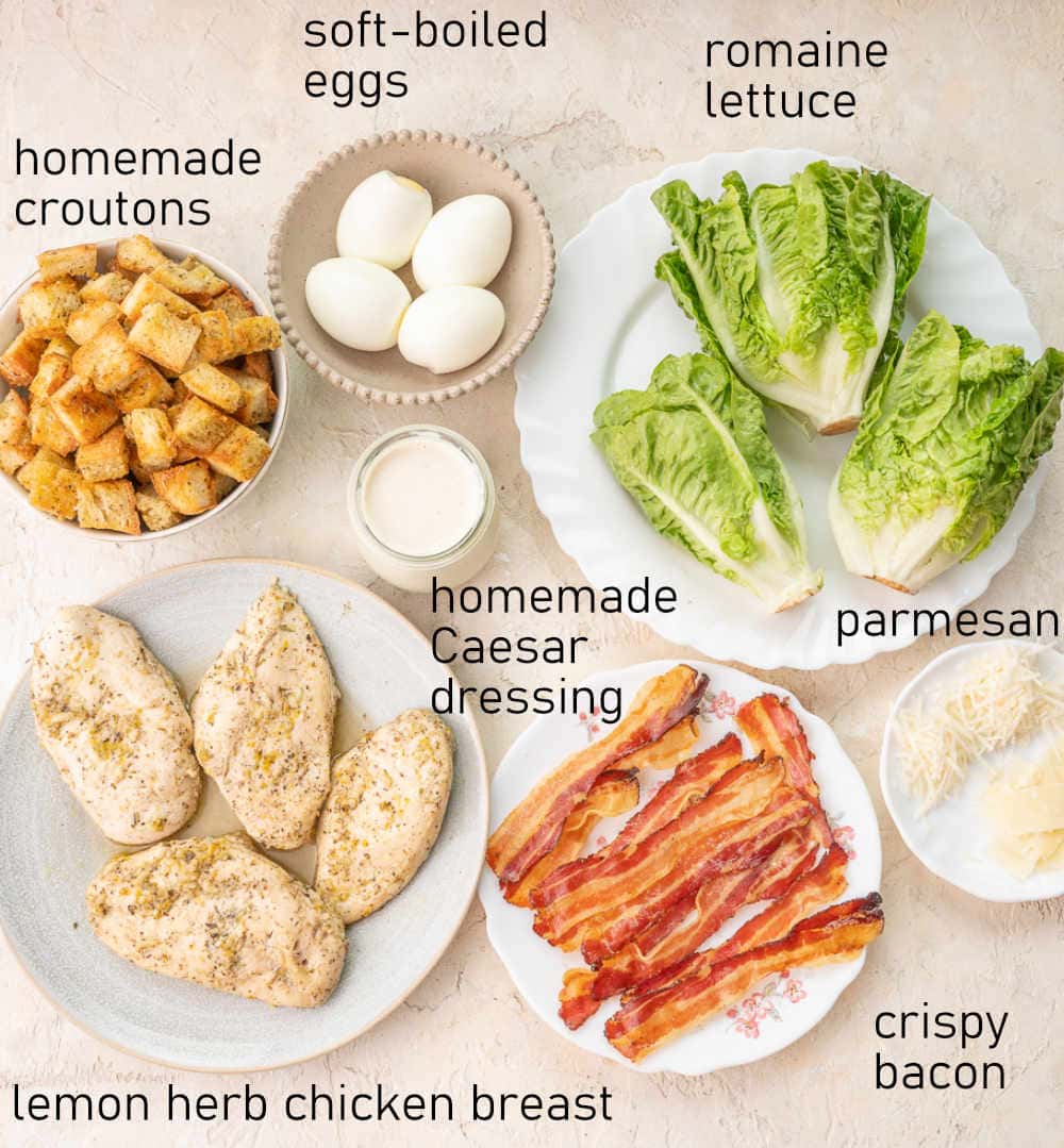 Labeled ingredients for chicken Caesar salad.