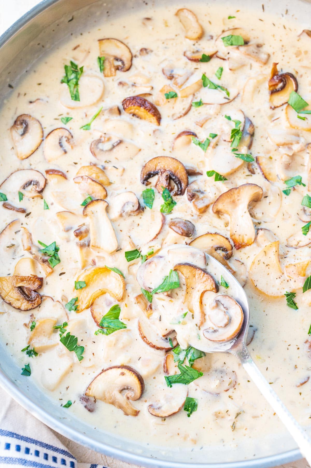 Creamy mushroom sauce in a large frying pan.