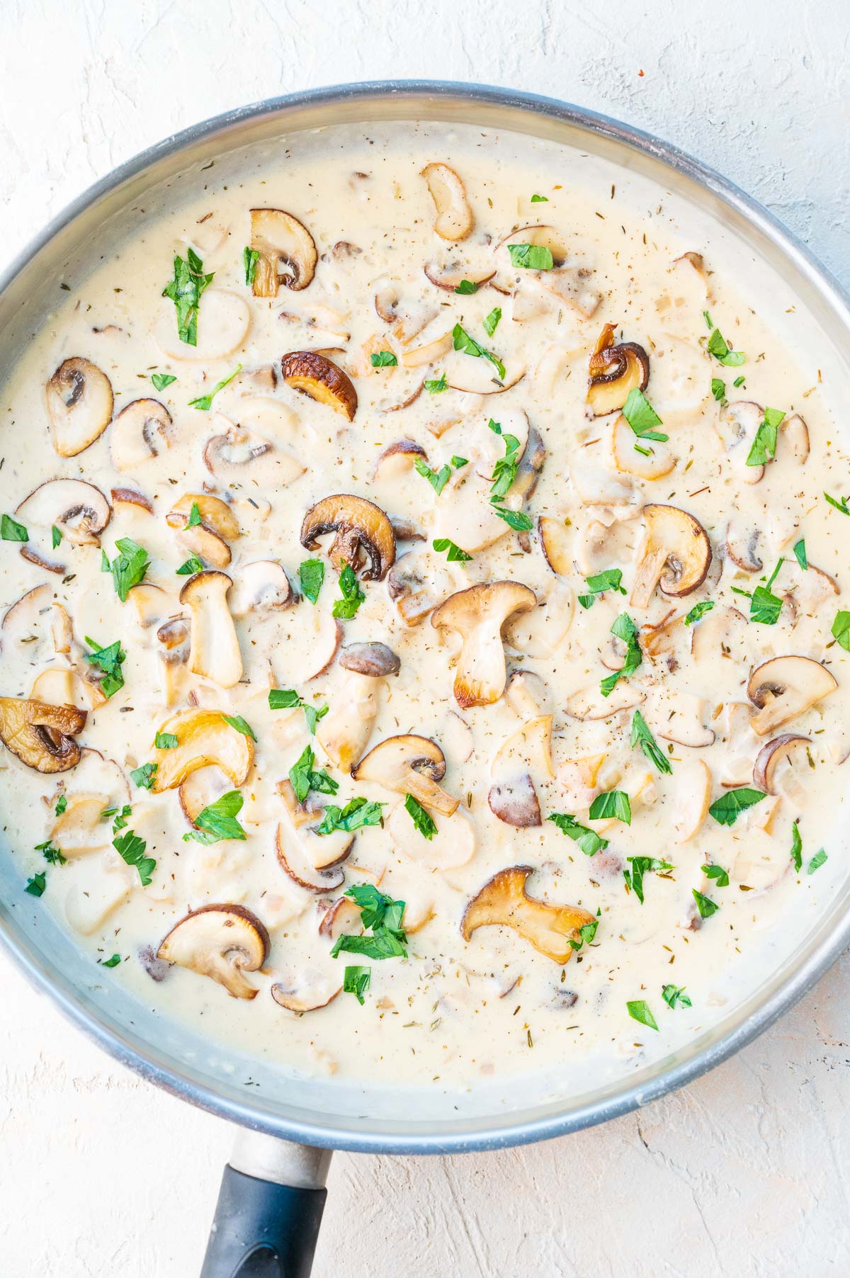 Creamy mushroom sauce in a large frying pan.