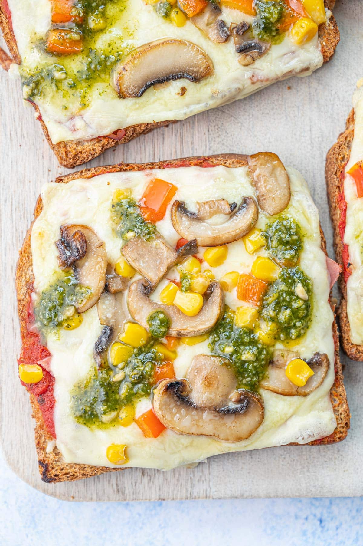 Pizza toast on a chopping board.