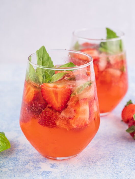 Strawberry basil cocktail in a glass.