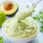 Avocado sauce in a white bowl.