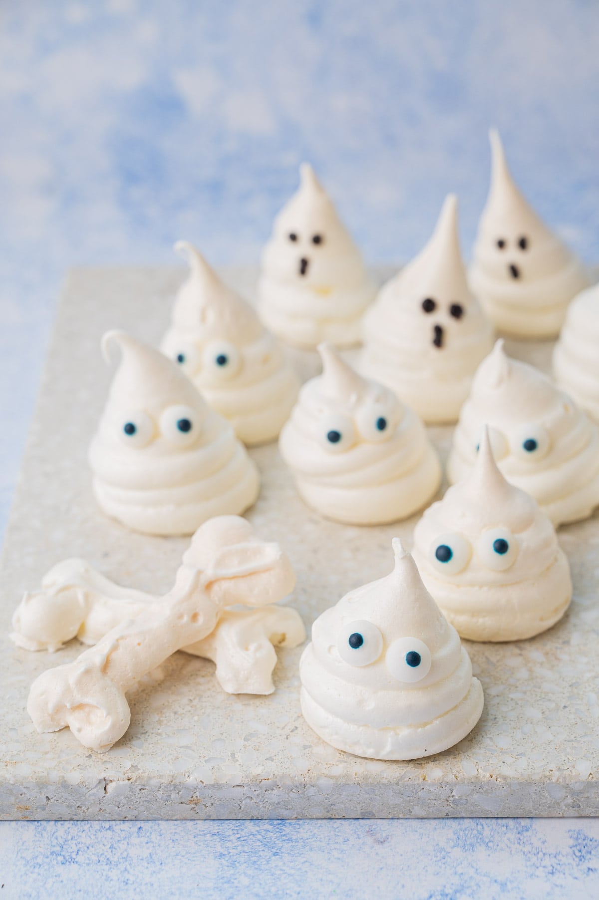 Meringue ghosts and bones on a stone background.