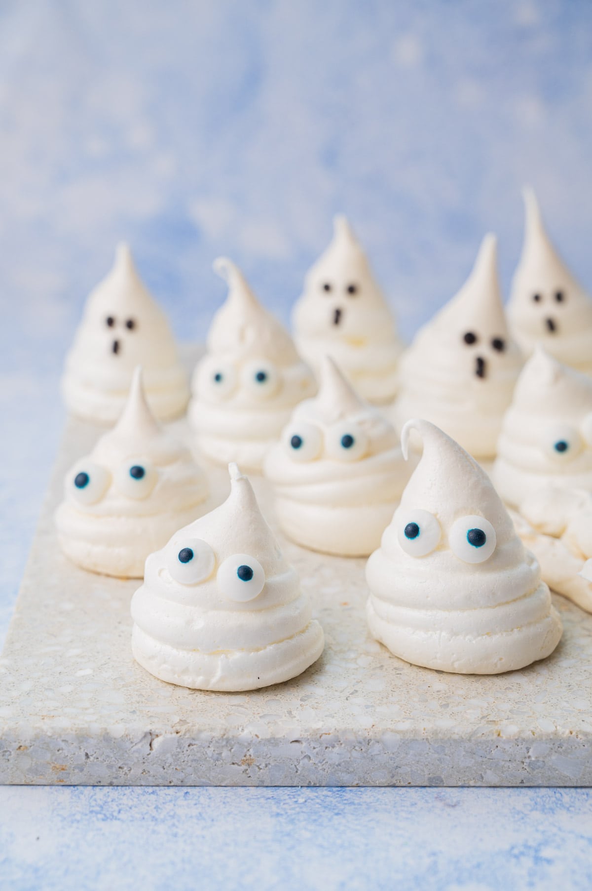 Meringue ghosts on a stone tray.