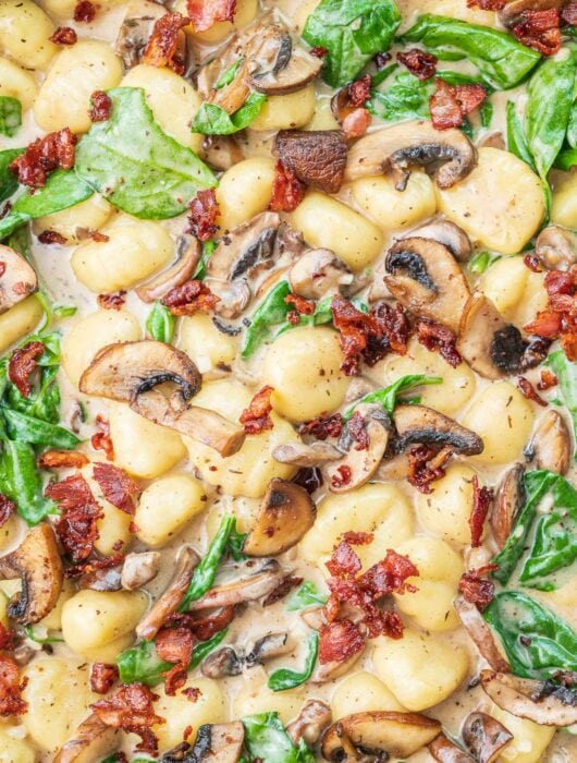 Mushroom gnocchi with spinach and bacon.