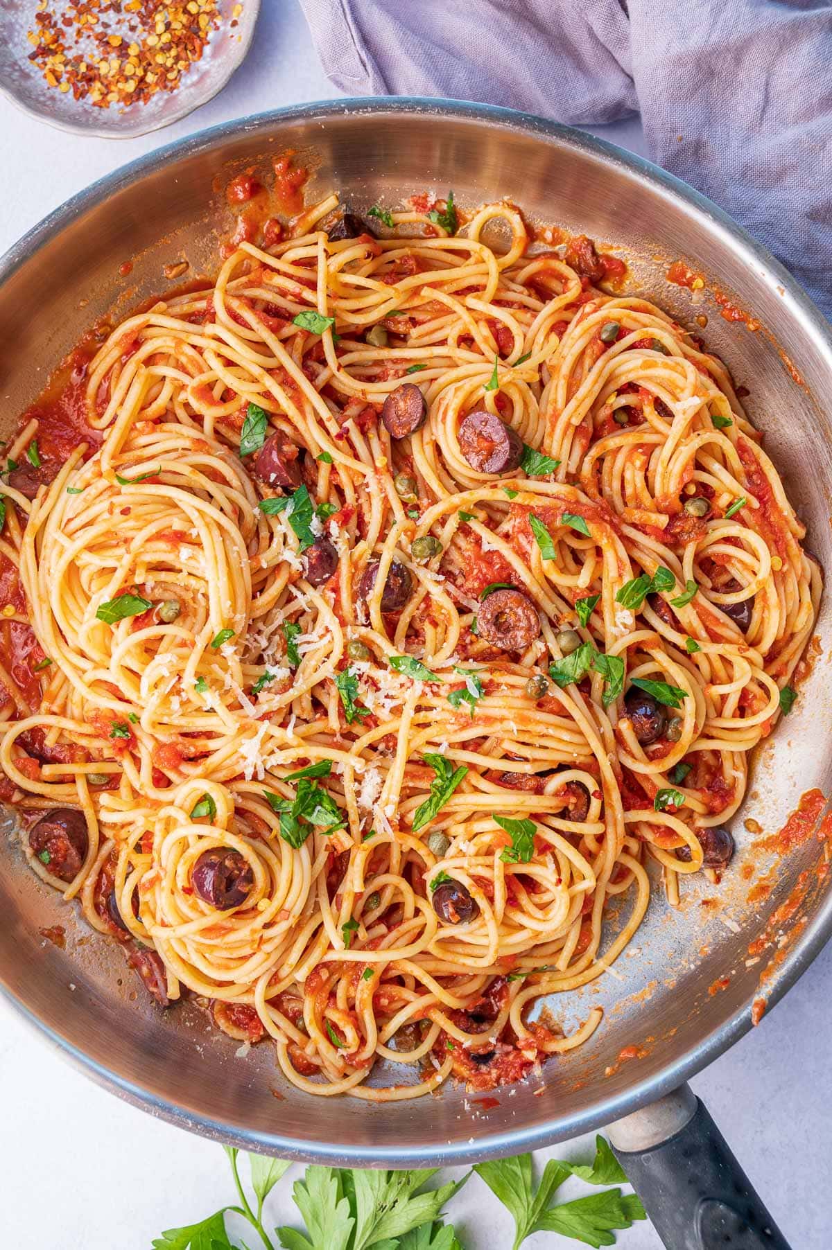 Pasta puttanesca in a frying pan.