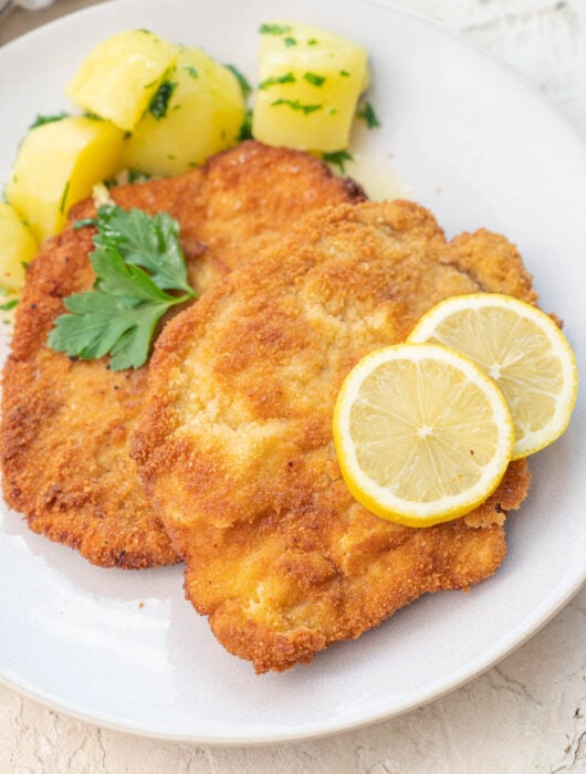 German pork Schnitzel on a beige plate.