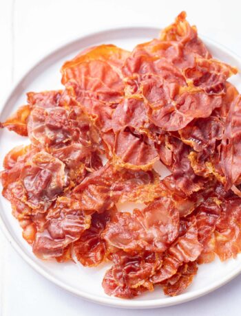 Crispy Prosciutto on a white plate.