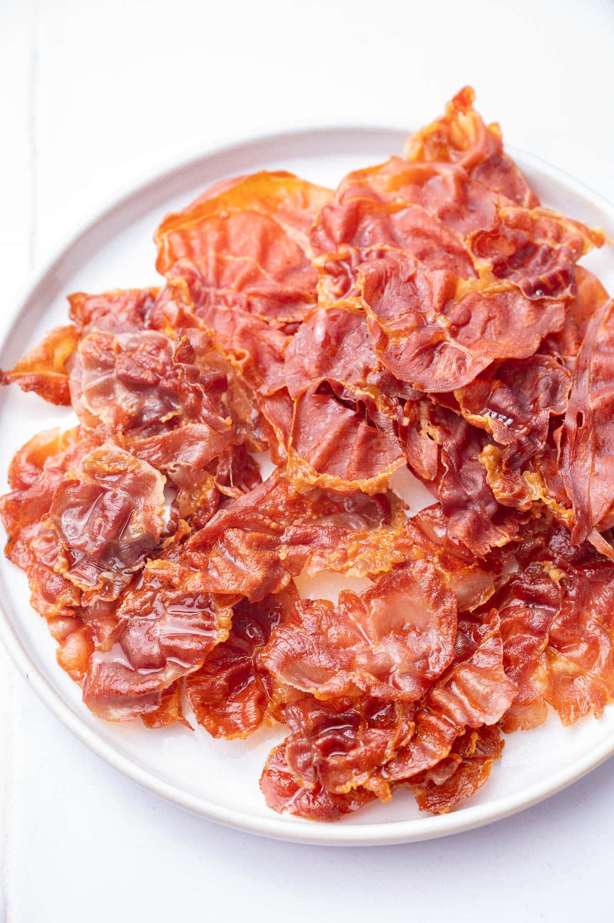 Crispy Prosciutto on a white plate.