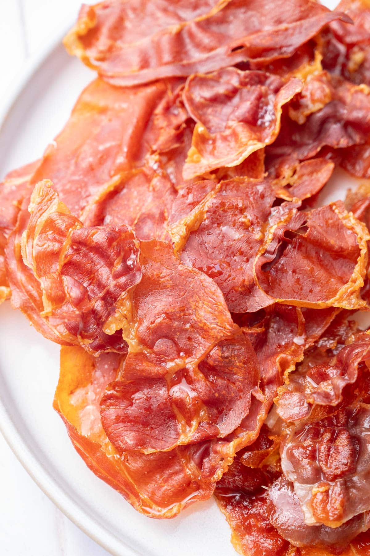 Crispy Prosciutto on a white plate.