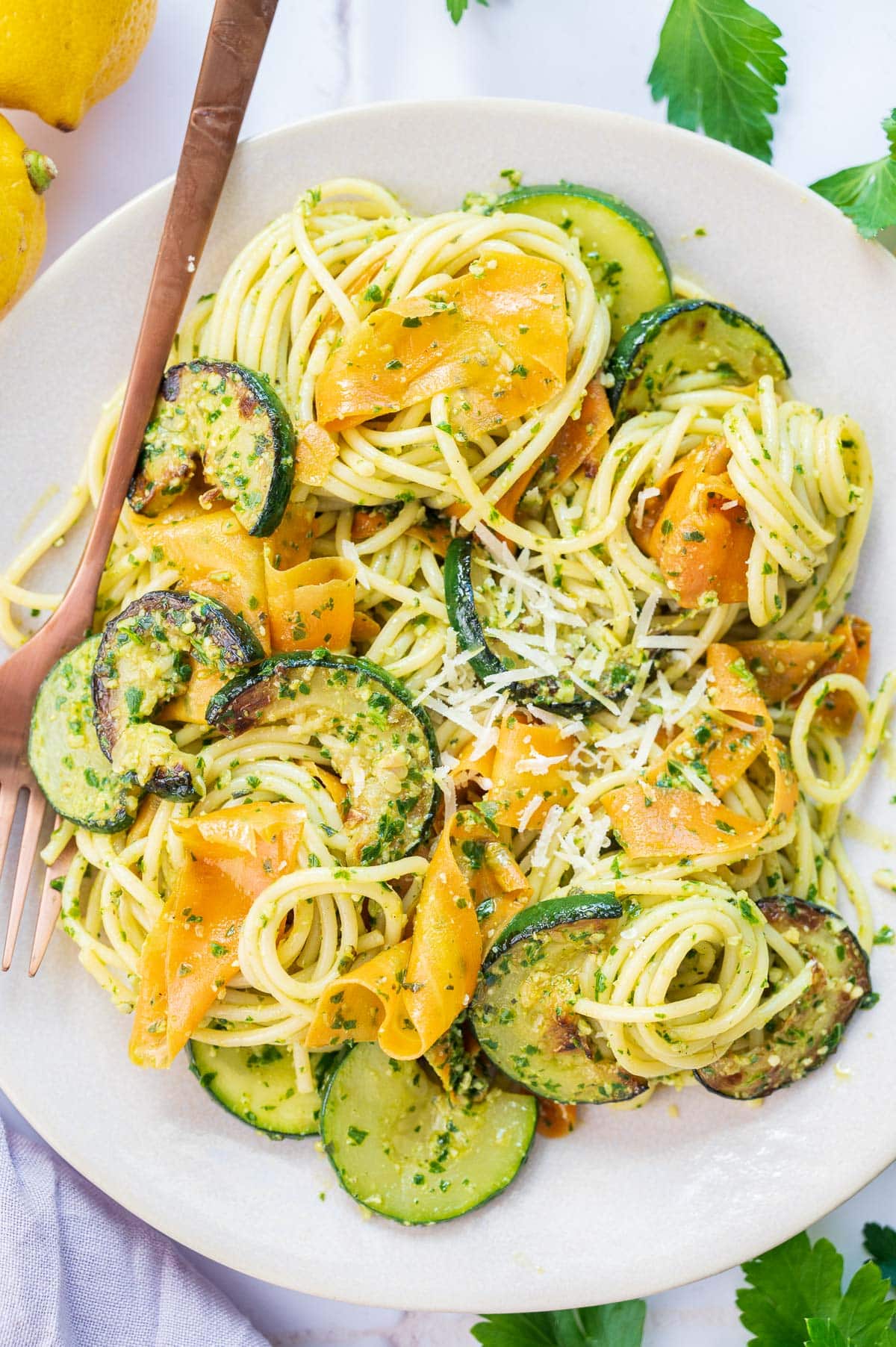 Parsley pesto pasta on a white plate.