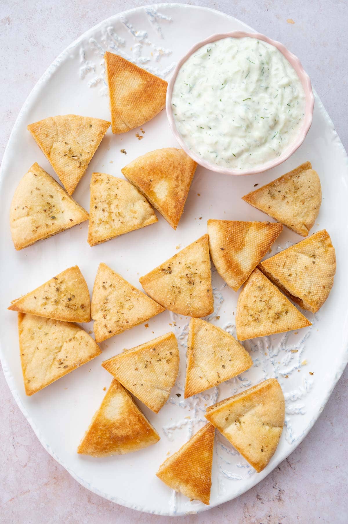 Overhead photo of pita chips on a white plate.