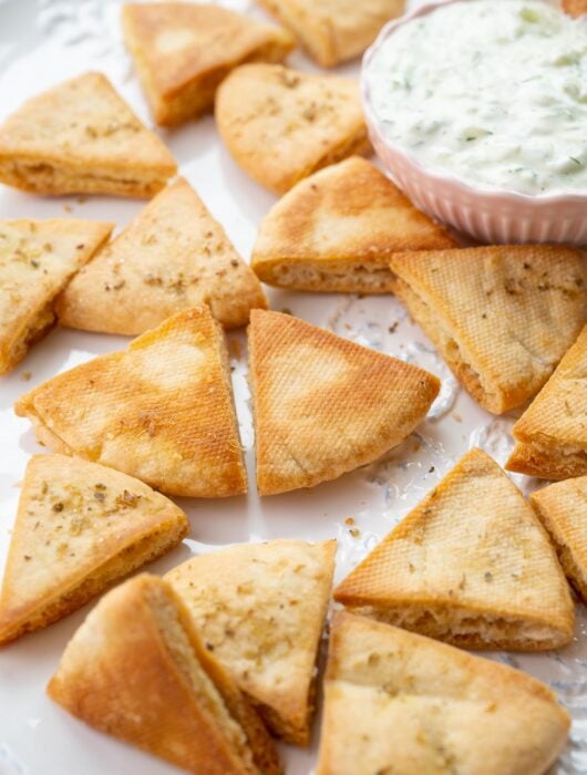 Pita chips on a white plate.