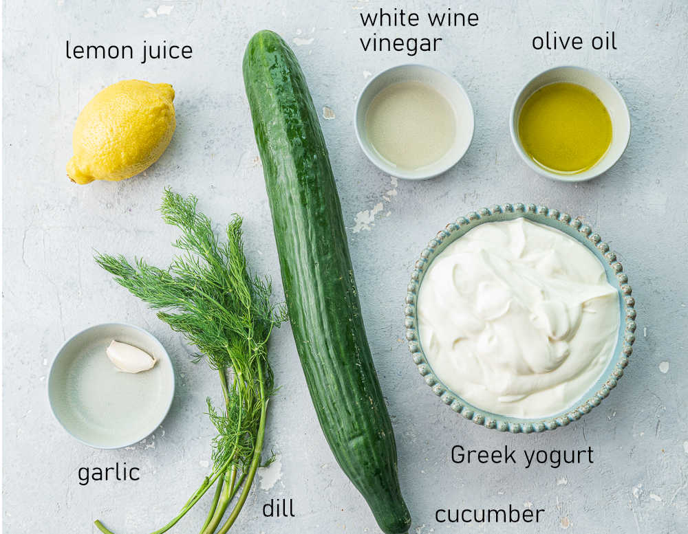 Labeled ingredients needed to prepare tzatziki dip.