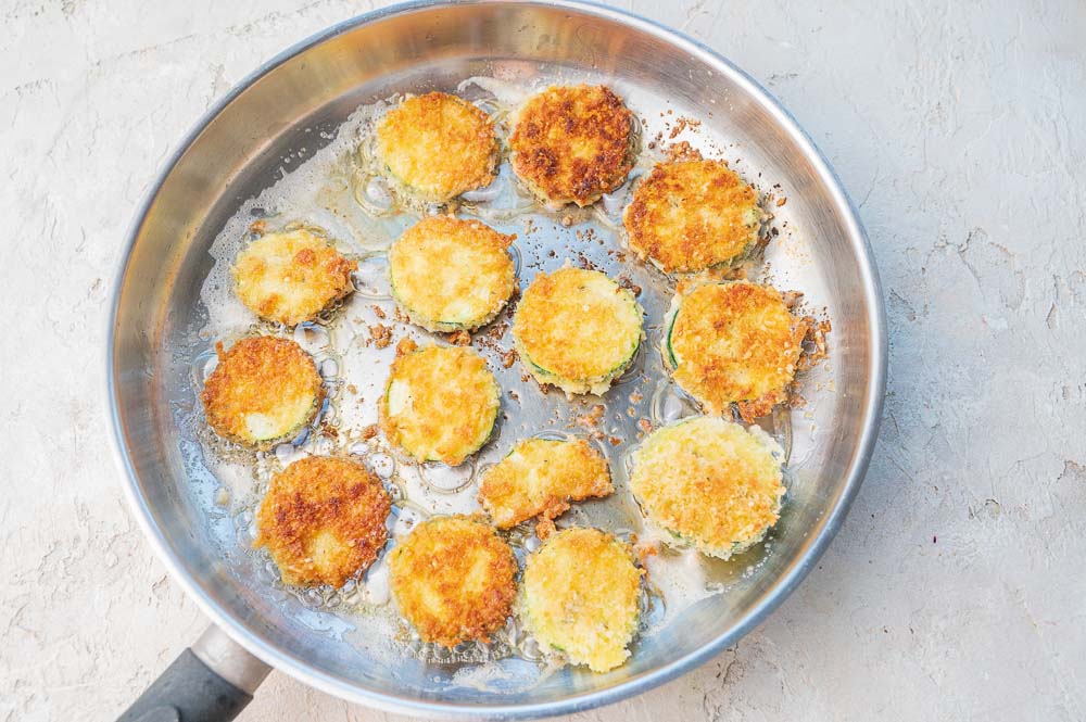 Zucchini fries in a frying pan.