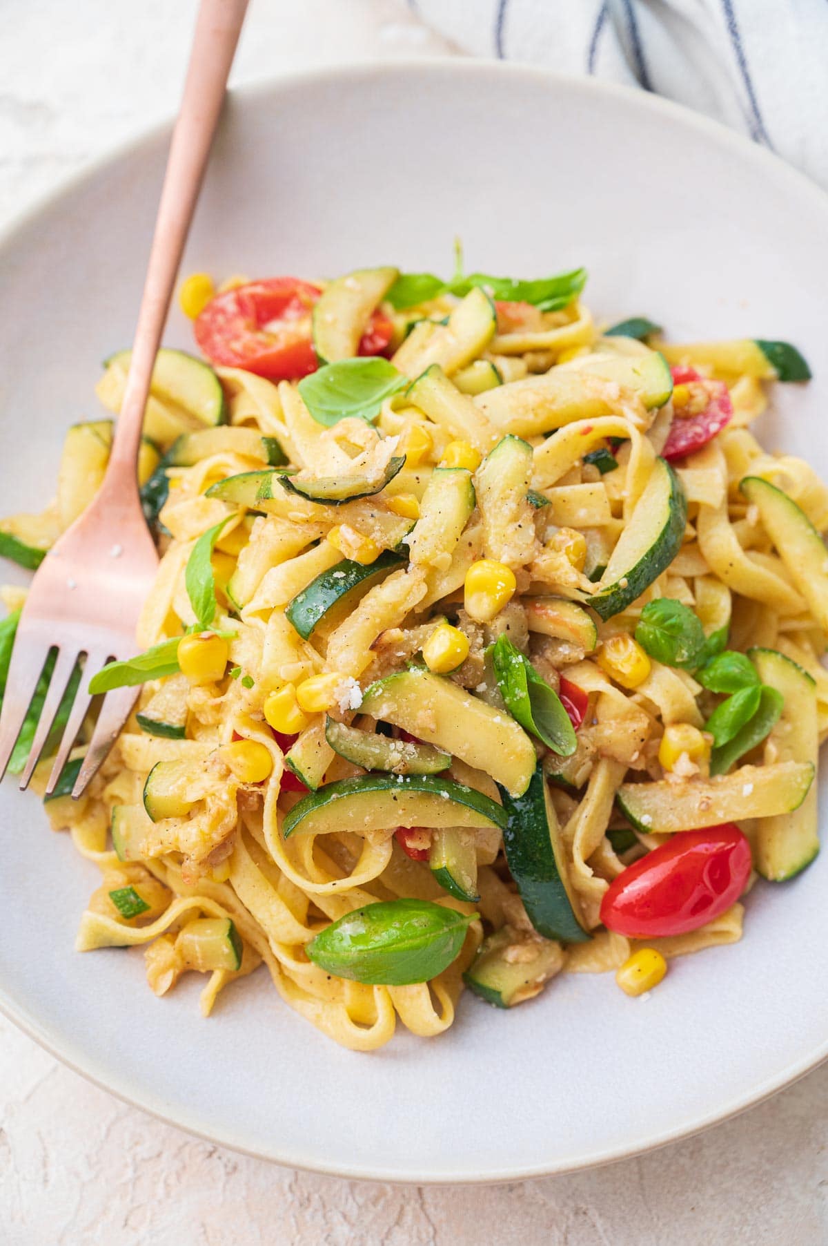 Zucchini pasta in a beige plate.