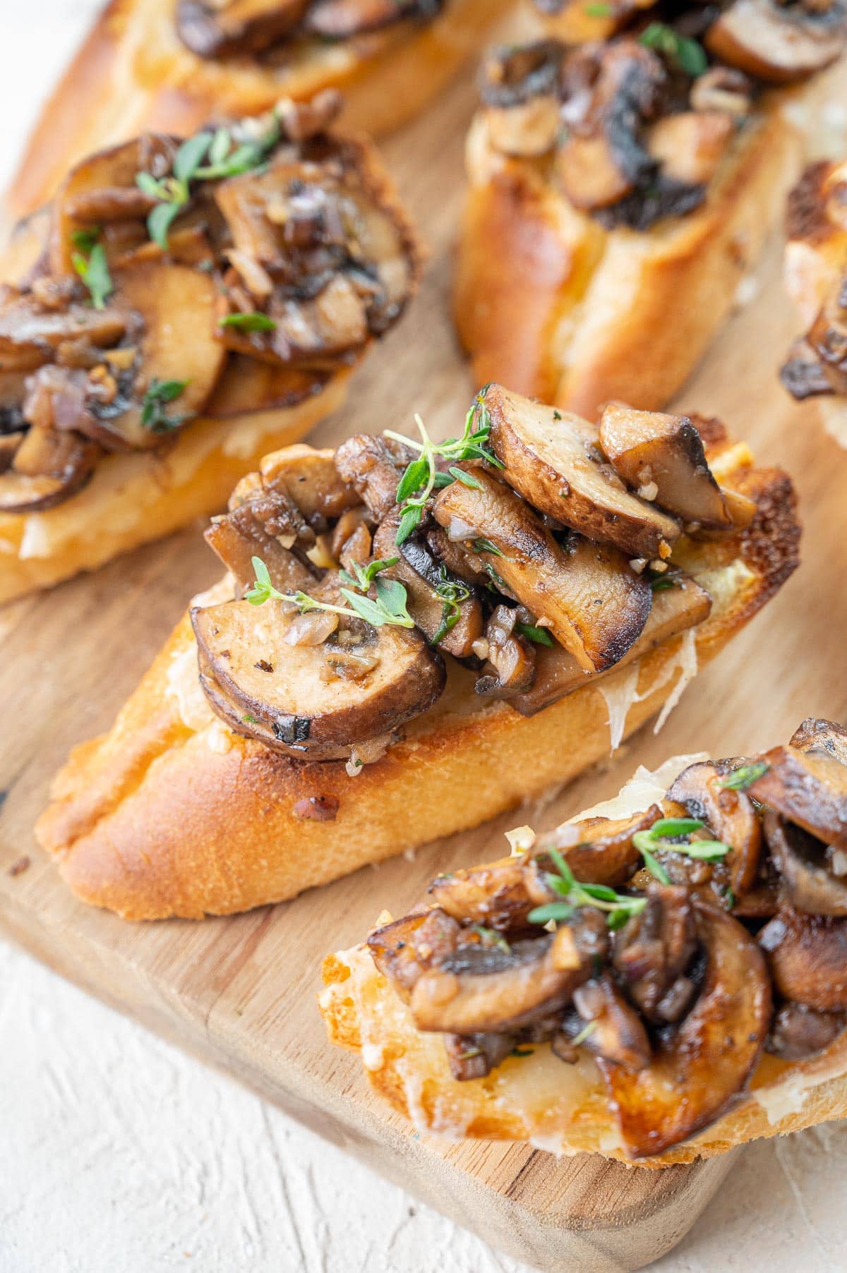 Mushroom bruschetta on a wooden board.